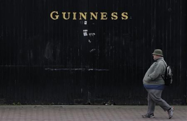 a man passes by a guiness beer factoryin dublin reuters a man passes by a guiness beer factoryin dublin reuters