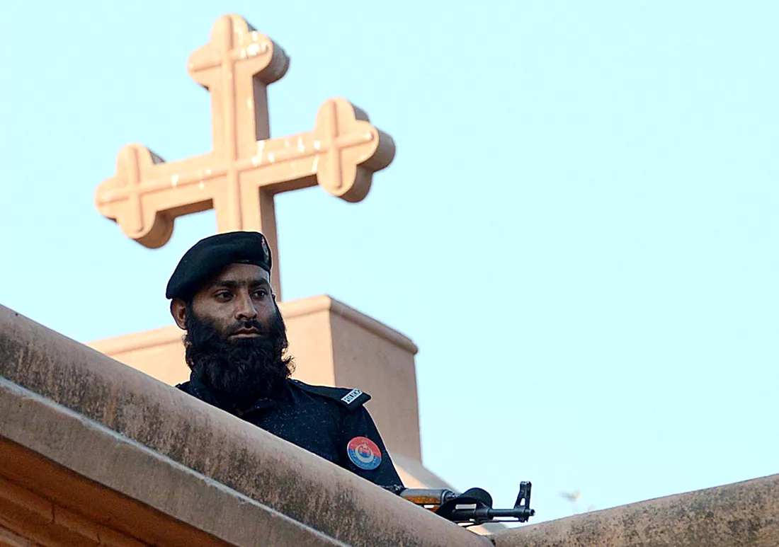 a policeman stands guard on the roof of a church during a special service for suicide bombing victims at a church in peshawar photo afp a policeman stands guard on the roof of a church during a special service for suicide bombing victims at a church in peshawar photo afp