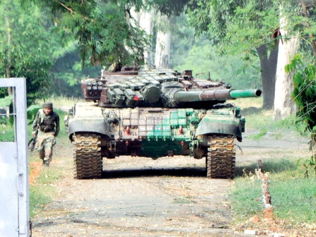 an indian soldier takes cover behind a tank used to force entry inside the officers mess of the army camp in samba during an attack by militants photo afp an indian soldier takes cover behind a tank used to force entry inside the officers mess of the army camp in samba during an attack by militants photo afp