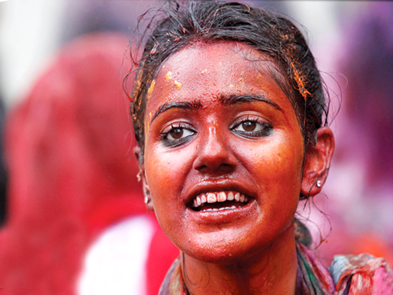 a girl smeared red on holi at the balimiki mandir anarkali the photographer is mohsin raza of reuters
