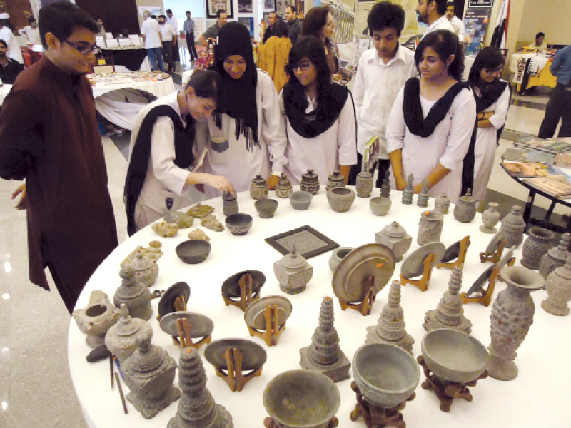 students looking at artefacts during world tourism day celebrations at pak china friendship centre photo inp