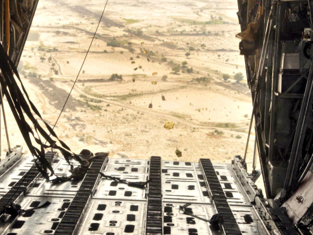 a c 130 of the pakistan air force paf drops relief goods in a earthquake affected area photo inp
