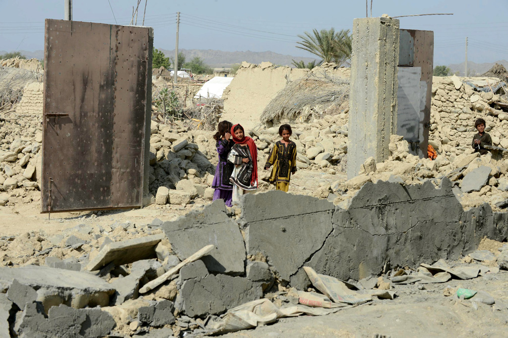 earthquake survivors gather around collapsed mud houses in the dhall bedi peerander area of the earthquake devastated district of awaran on september 27 2013 photo afp