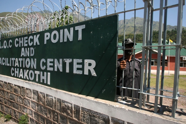 in this photograph taken on september 18 2013 a kashmiri security guard looks out of the truck check point at the line of control loc in chakothi photo afp