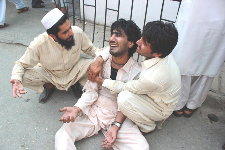 locals try to console a family member at the hospital after the qissa khwani attack photo muhammad iqbal express