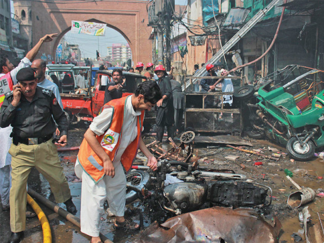 rescue workers sift through the remains of vehicles at qissa khwani bazaar photo muhammad iqbal express rescue workers sift through the remains of vehicles at qissa khwani bazaar photo muhammad iqbal express