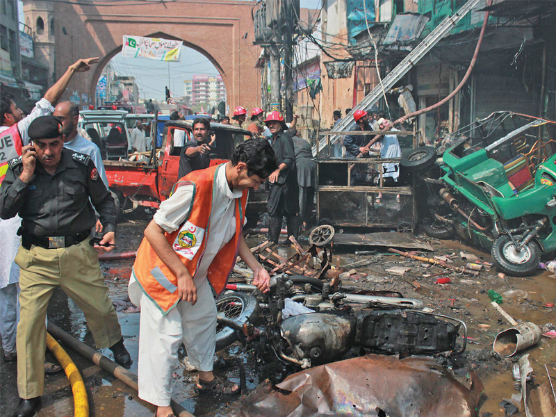 rescue workers sift through the remains of vehicles at qissa khwani bazaar photo muhammad iqbal express