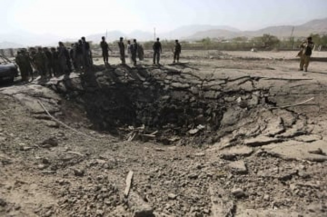 afghan policemen look on a crater at the scene of suicide attack in maidan shar the capital of wardak province photo reuters