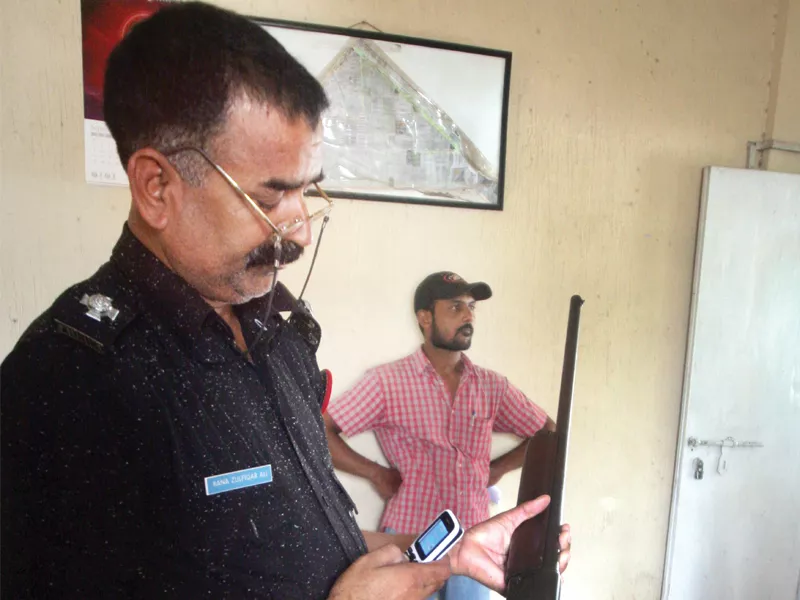 a policeman holds the belgian brownin shotgun that a man tried to surrender at gizri police station photo athar khan express a policeman holds the belgian brownin shotgun that a man tried to surrender at gizri police station photo athar khan express