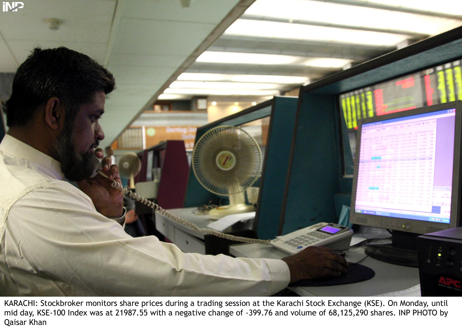 a stockbroker monitors share prices during a trading session photo inp file