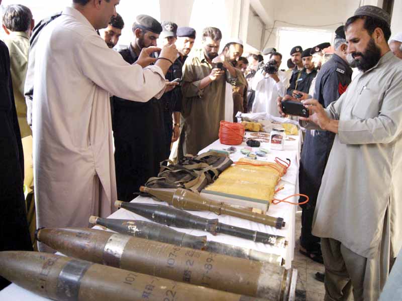 policemen displaying weapons recovered from members of the terrorist organisation amaraat e islami photo online
