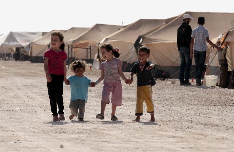 syrian refugee children walk among camps at the zaatri refugee camp near teh jordanian border with syria on september 11 2012 photo afp