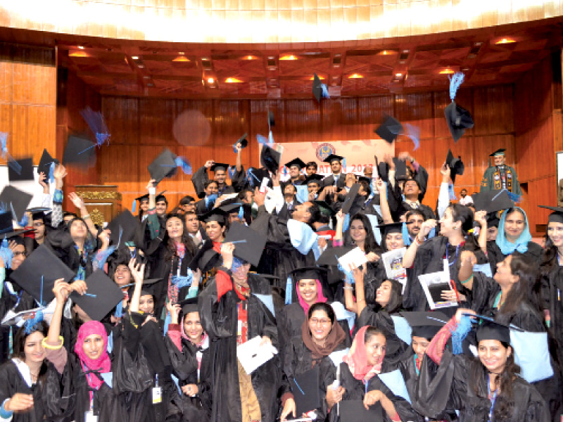 graduates ceremoniously throw their mortarboards in the air after the convocation ceremony photo express