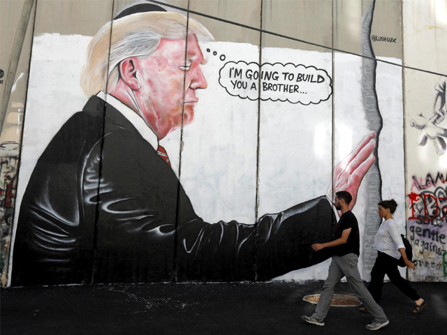 a mural resembling the work of elusive artist banksy depicting president donald trump wearing a jewish skullcap is seen on israel 039 s west bank separation barrier in the west bank city of bethlehem photo ap a mural resembling the work of elusive artist banksy depicting president donald trump wearing a jewish skullcap is seen on israel 039 s west bank separation barrier in the west bank city of bethlehem photo ap