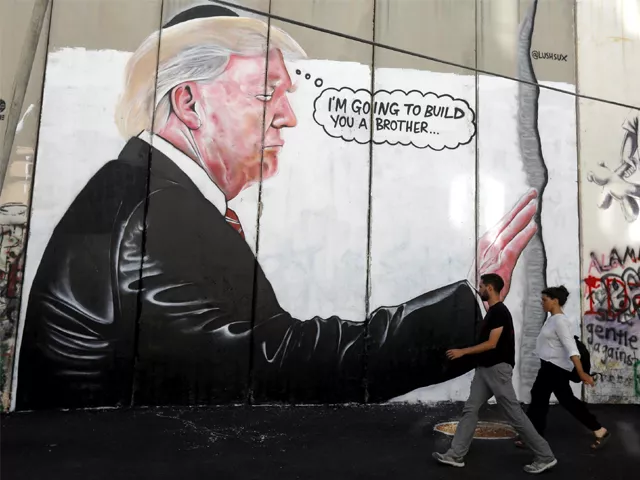 a mural resembling the work of elusive artist banksy depicting president donald trump wearing a jewish skullcap is seen on israel 039 s west bank separation barrier in the west bank city of bethlehem photo ap a mural resembling the work of elusive artist banksy depicting president donald trump wearing a jewish skullcap is seen on israel 039 s west bank separation barrier in the west bank city of bethlehem photo ap