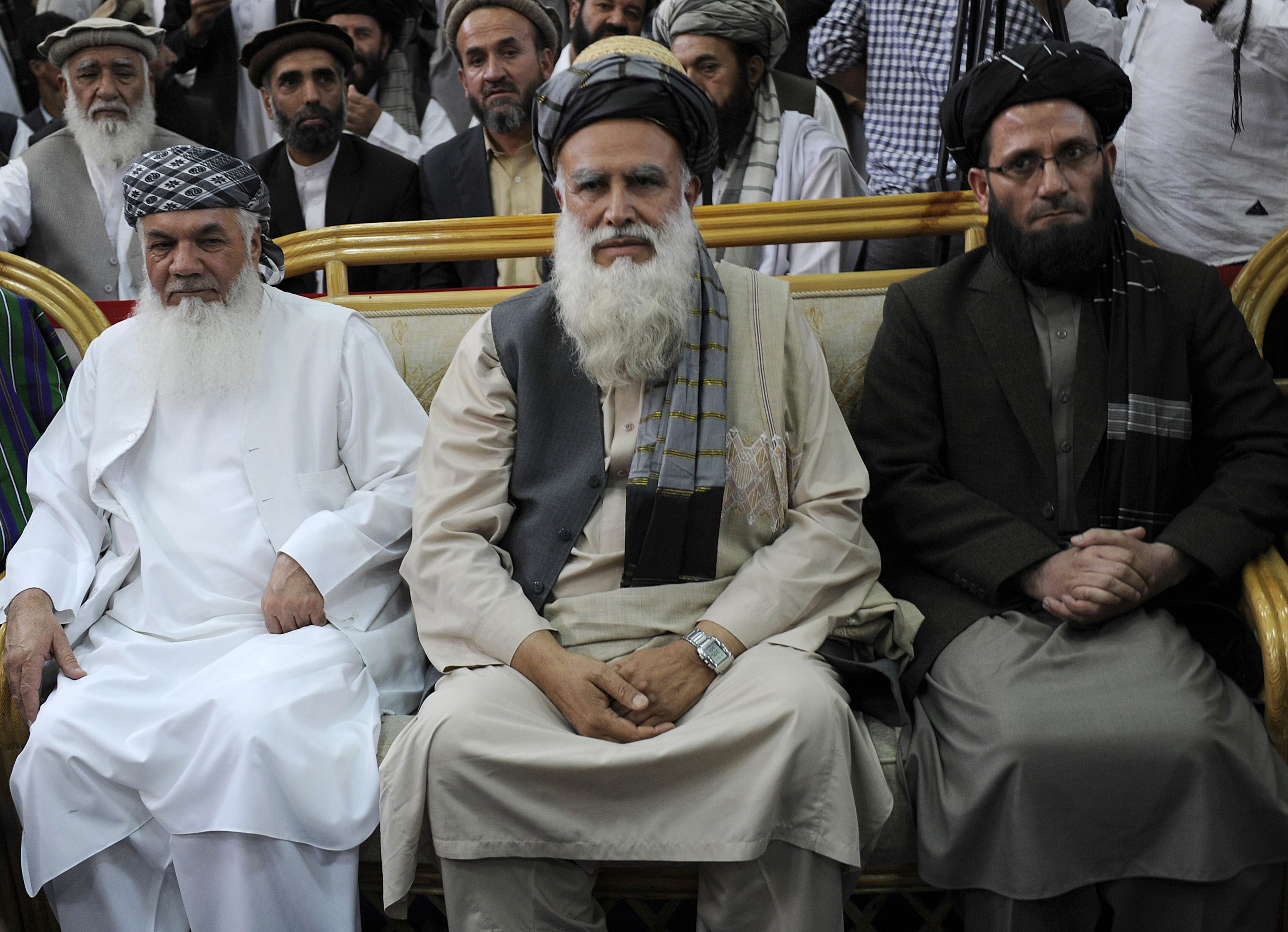 former warlord abdul rasul sayyaf c sits with his two vice presidential candidates mohammad ismail khan l and abdul wahab erfan during a registration process for the presidential elections in kabul on october 3 2013 photo afp