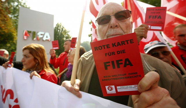 a members of the swiss unia workers union displays a red card during a protest in front of the headquarters of soccer 039 s international governing body fifa in zurich october 3 2013 photo reuters a members of the swiss unia workers union displays a red card during a protest in front of the headquarters of soccer 039 s international governing body fifa in zurich october 3 2013 photo reuters