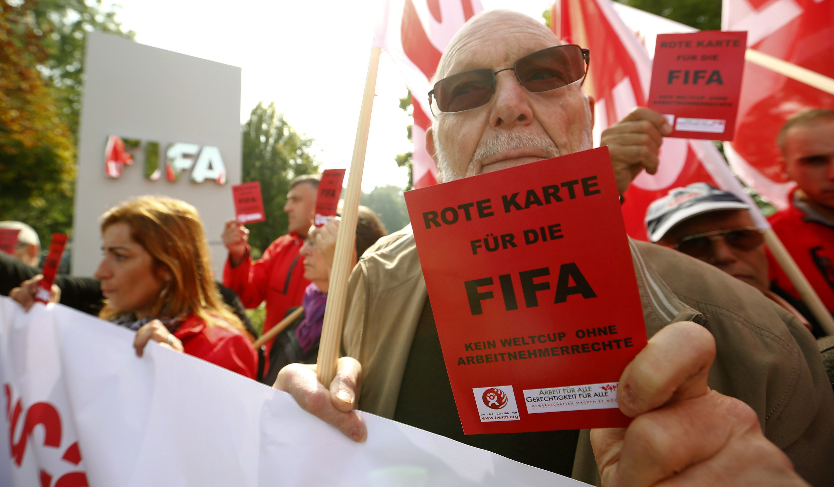 a members of the swiss unia workers union displays a red card during a protest in front of the headquarters of soccer 039 s international governing body fifa in zurich october 3 2013 photo reuters