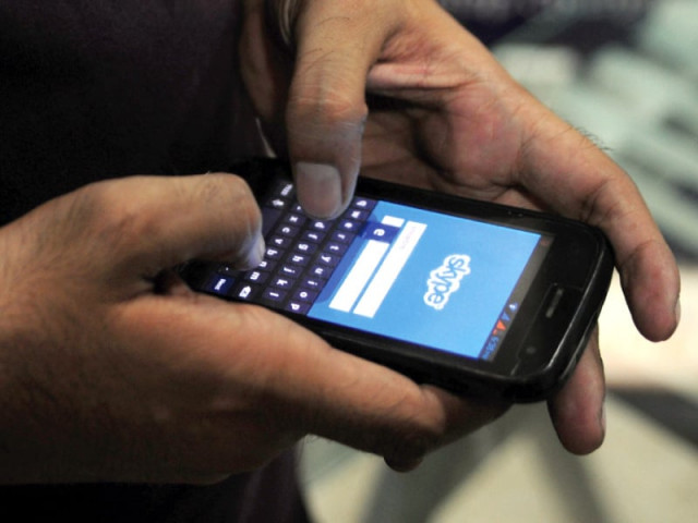 a person uses skype app on his cell phone photo afp a person uses skype app on his cell phone photo afp