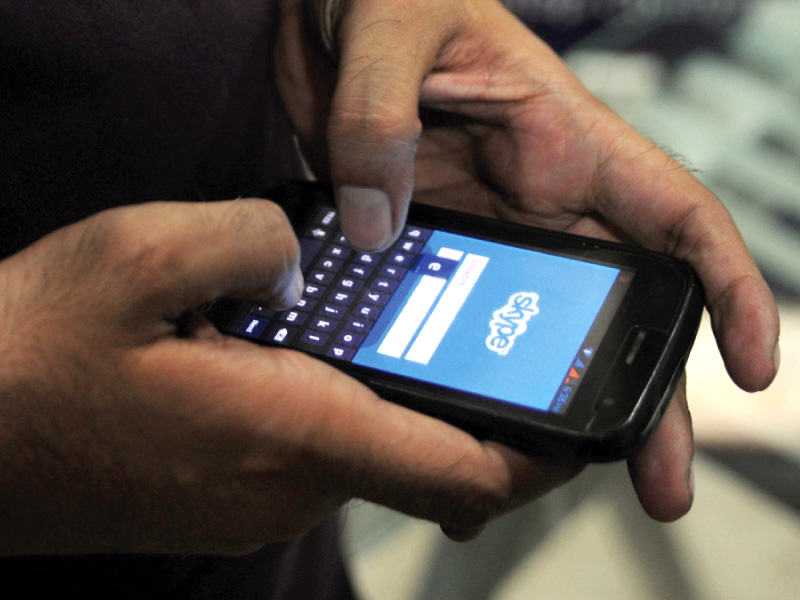 a person uses skype app on his cell phone photo afp