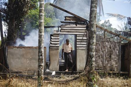 a man walks out from a destroyed mosque that was burnt down in recent violence at tha pyu chai village photo reuters