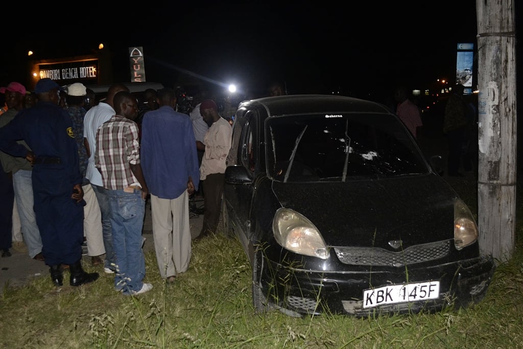 kenyans gather around a bullet riddled after muslim cleric was killed in a drive by shooting on the mombasa malindi highway photo afp