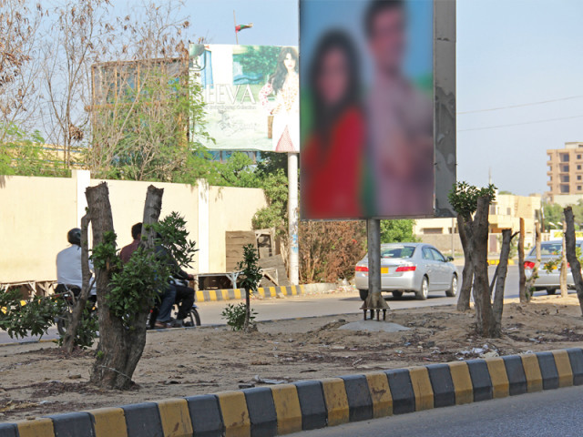 the authorities recently chopped up half the trees in front of dolmen shopping mall in clifton and permitted advertisers to put up a number of hoardings at the centre island the patch of trees between two roads photo ayesha mir express the authorities recently chopped up half the trees in front of dolmen shopping mall in clifton and permitted advertisers to put up a number of hoardings at the centre island the patch of trees between two roads photo ayesha mir express