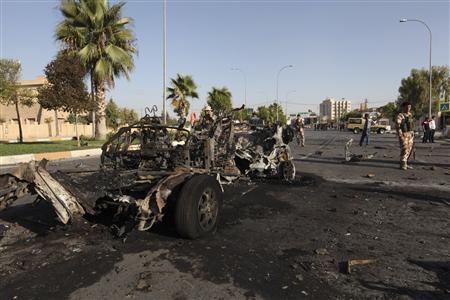 kurdish security forces inspect the site of a bomb attack in the city of arbil photo reuters