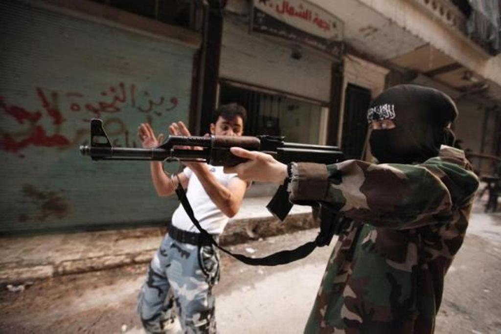 a female member of the quot mother aisha quot battalion receives instruction as she holds a rifle during military training in aleppo 039 s salaheddine district september 19 2013 photo reuters