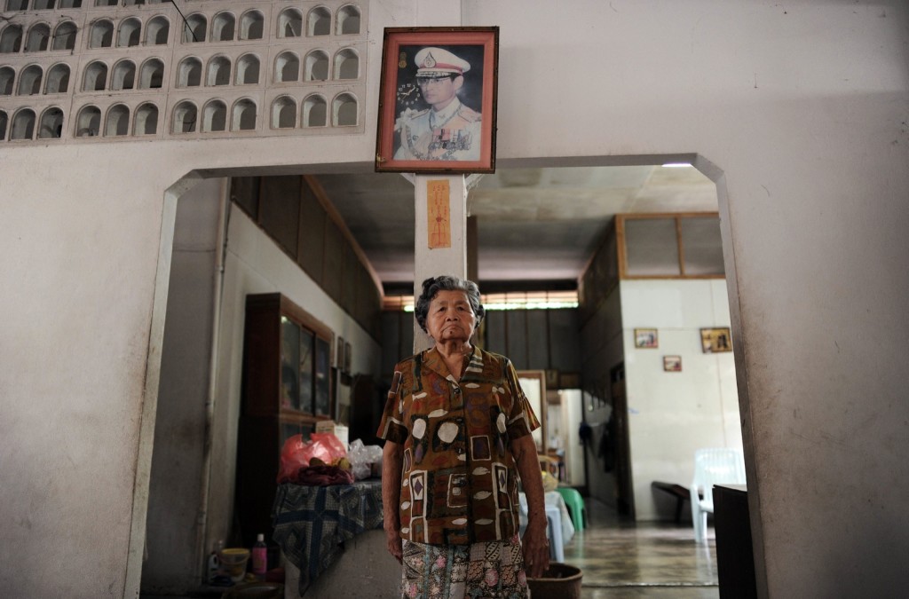 81 year old thai grandmother jiaw pongthawil portrayed under a framed picture of revered king bhumibol adulyadej at her home in baan ga doh photo afp