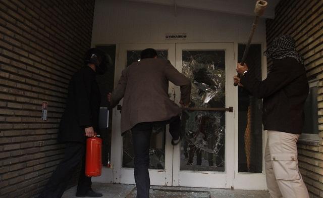 protesters break through a door in the british embassy compound in tehran on nov 29 2011 photo reuters