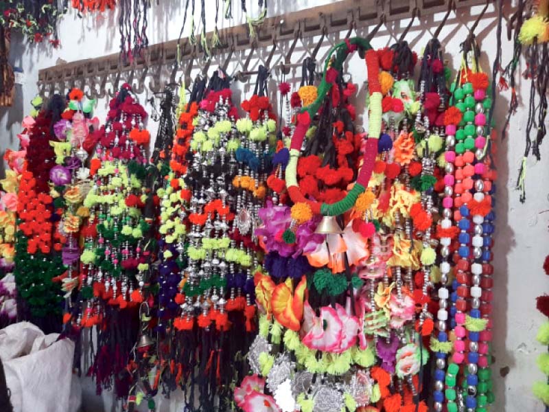 multicoloured garlands for sacrificial animals hang from the wall of a stall in rawalpindi photo express