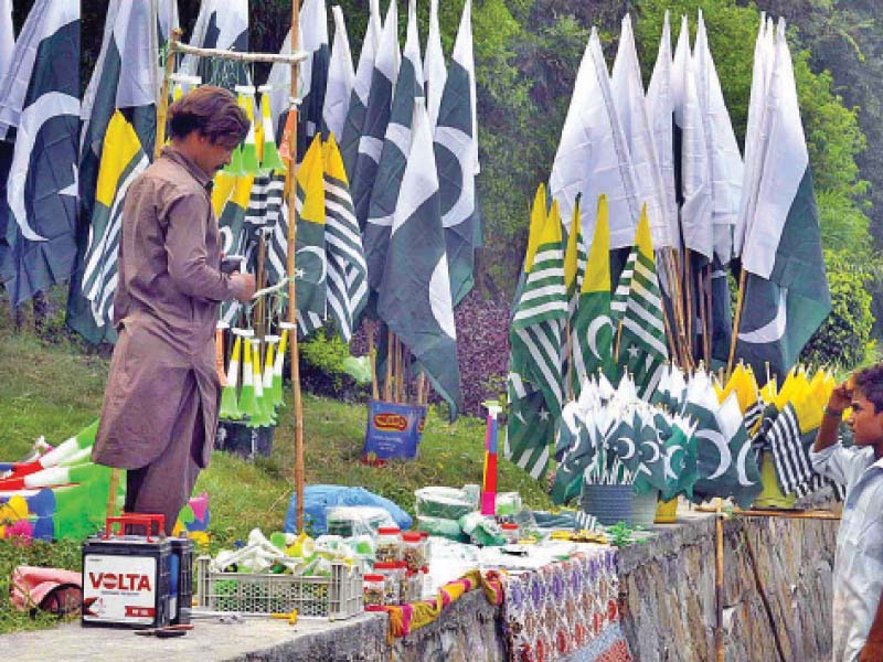 a vendor sells flags and badges on a roadside in the capital photo app