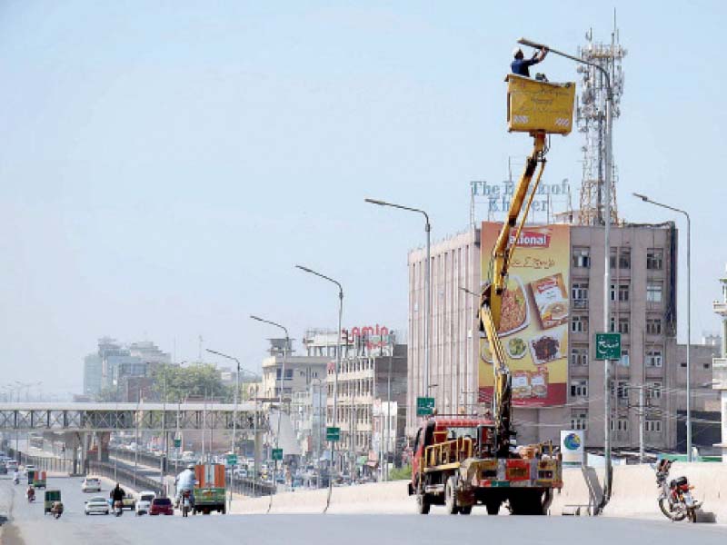 workers block a road with a container on the route of the mourning procession for the chehlum photo app