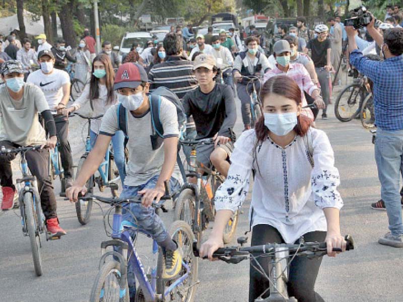 people take part in a cycle rally held at the rose and jasmine garden to create awareness about climate change impact pho to app