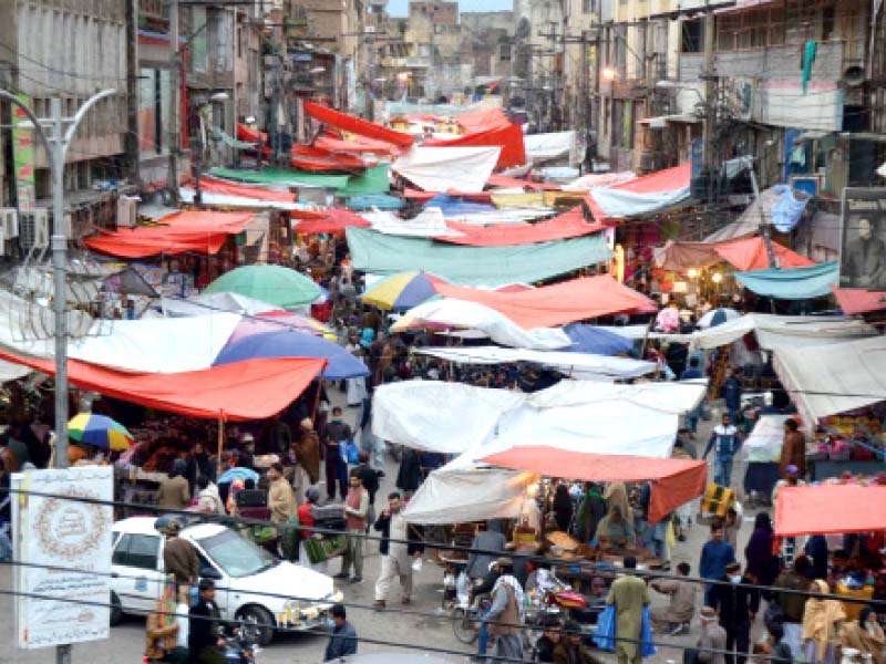 stalls covered with tarps have blocked an entire lane in bara market causing traffic congestion photo inp