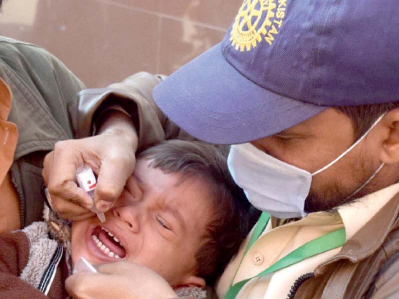 a health worker administers anti polio drops to a child in hyderabad photo inp