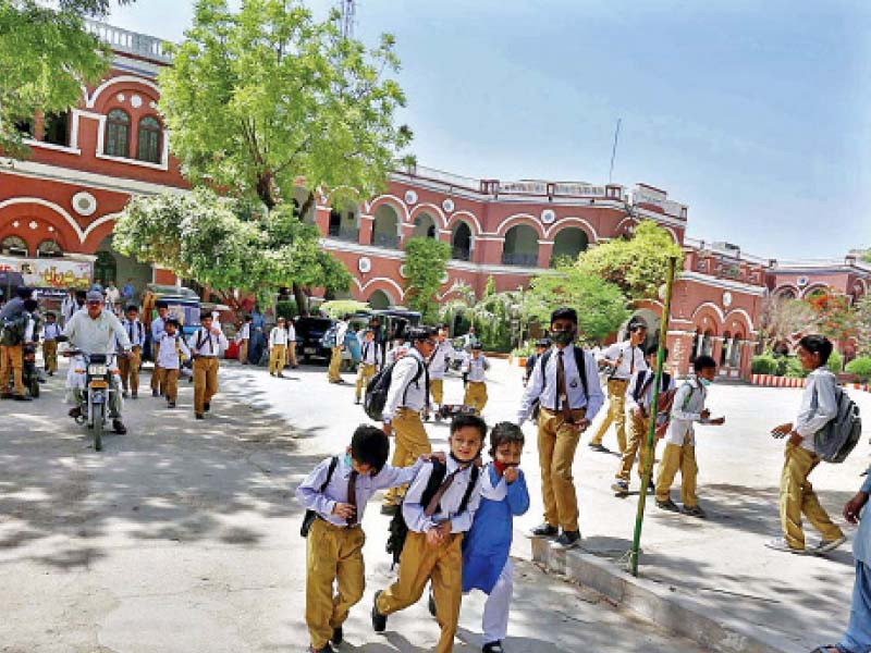 young students head home after a day at school under coronavirus mandated restrictions on campus classes for schools in sindh have been suspended for two weeks beginning today tuesday photo app