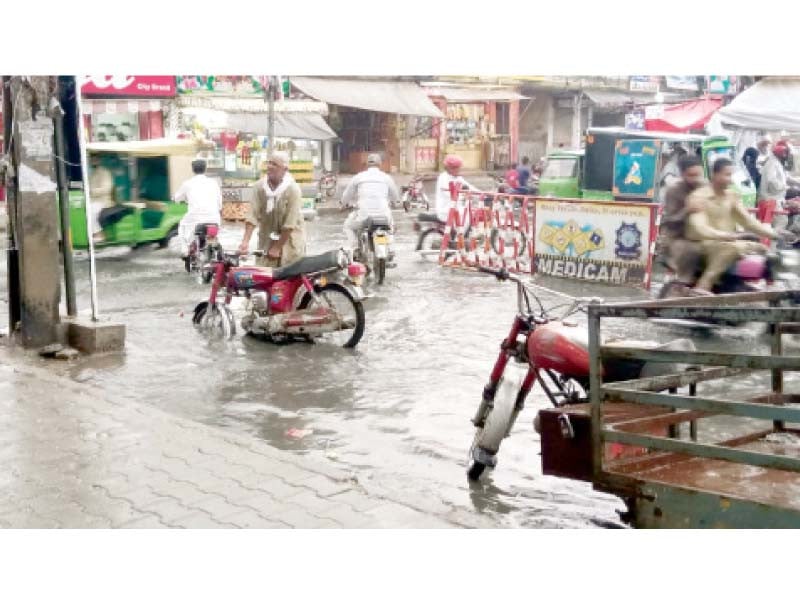 a stranded motorcyclist struggles to get his bike up and running after it gets stuck in a ditch on a submerged road near baraf khana chowk in dhoke syedan rawalpindi photo express