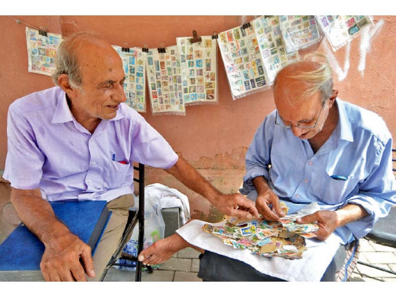 stamp vendors inayat ali and feroz ali show their collection of pakistani and international postage stamps as well as the rare gold stamp issued on the 100th birth anniversary of quaid i azam photos jalal qureshi express