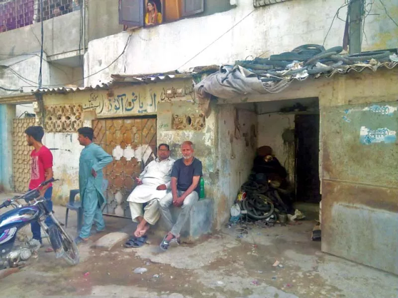 two men sit on the cement bench outside the siraj cycle shop in liaquatabad no 3 where umar sharif and moin akhtar used to hang out with friends when they lived here photo express two men sit on the cement bench outside the siraj cycle shop in liaquatabad no 3 where umar sharif and moin akhtar used to hang out with friends when they lived here photo express