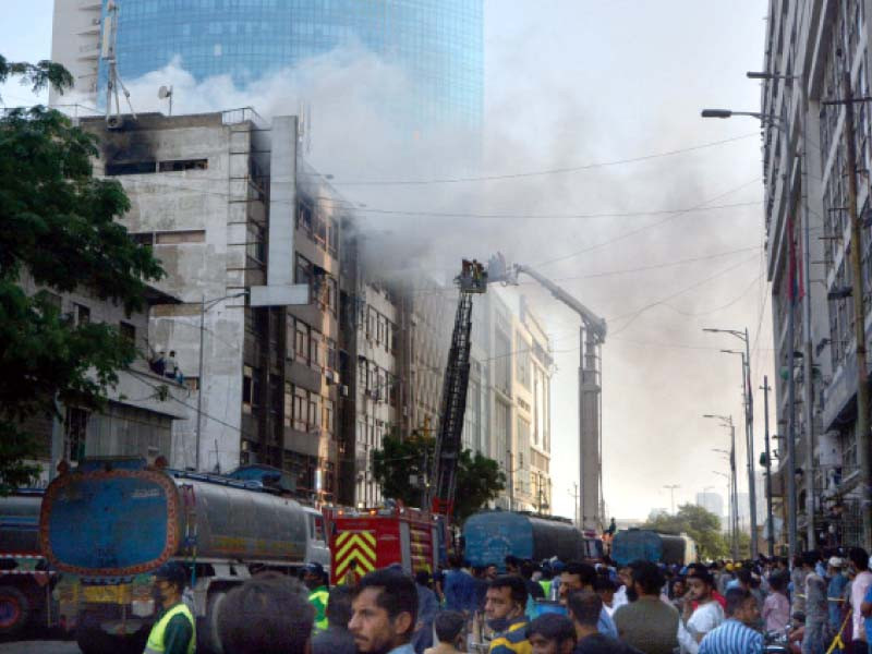 firefighters struggle to put out the inferno on the fifth floor of victoria centre in the shopping hub of saddar on wednesday photo jalal qureshi express