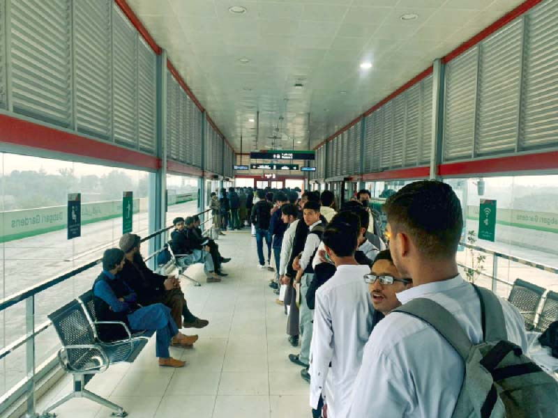 a long queue of commuters wait for their turn to hop onto a brt bus ride photo express