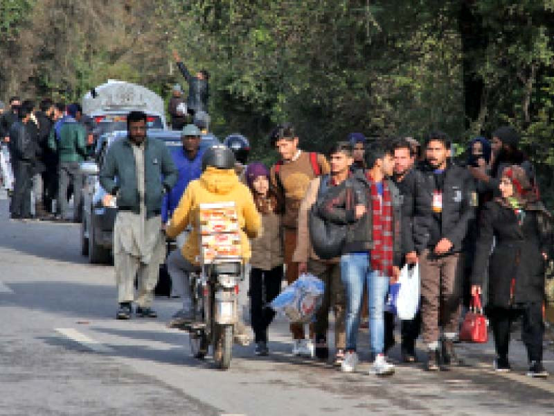 rescue teams of islamabad police assist tourists returning on foot from murree photo express