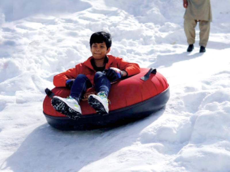a boy enjoys a favourite pastime snow tube sliding during the festivities photos ppi