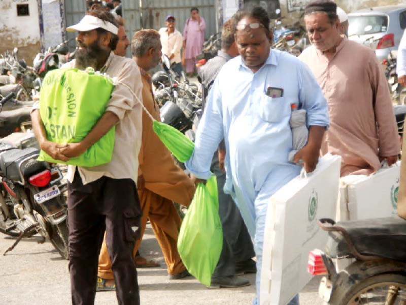 election commission of pakistan ecp staff carry material for use in polls photo jalal qureshi express