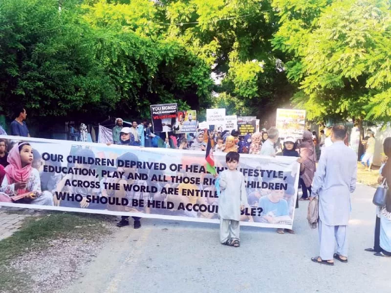 afghan refugees hold placards and banners during their protest outside npc photos express afghan refugees hold placards and banners during their protest outside npc photos express
