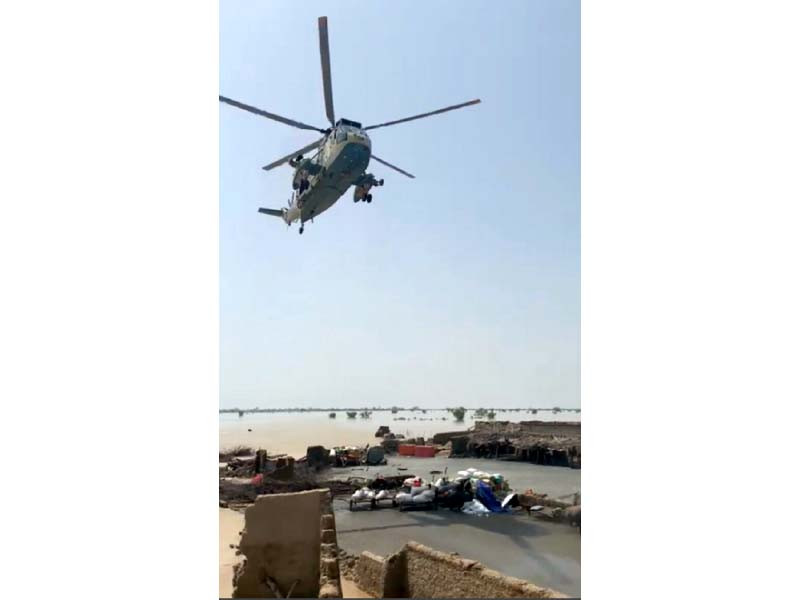 a sea king helicopter delivers supplies to people marooned by flood in sindh photo express