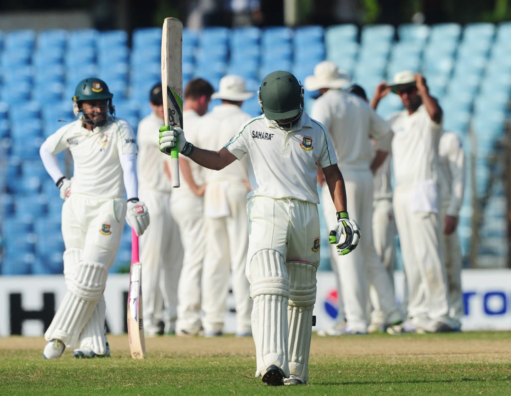 bangladesh batsman mominul haque front leaves the field as new zealand cricketers celebrate his dismissal during the third day of the first cricket test match between bangladesh and new zealand photo afp