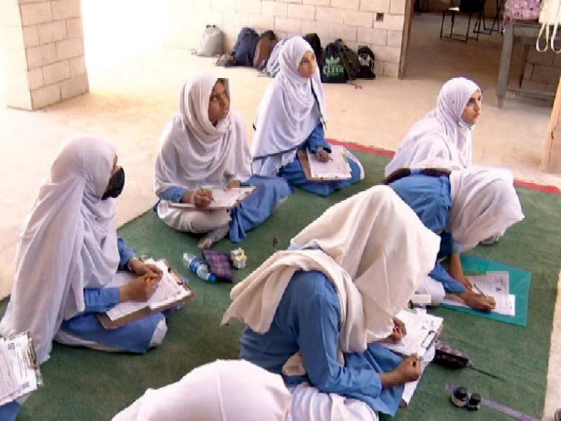 girls sit on a rug to solve a paper during matric exams at a government schools which did not have enough seats for all of the candidates photo express file